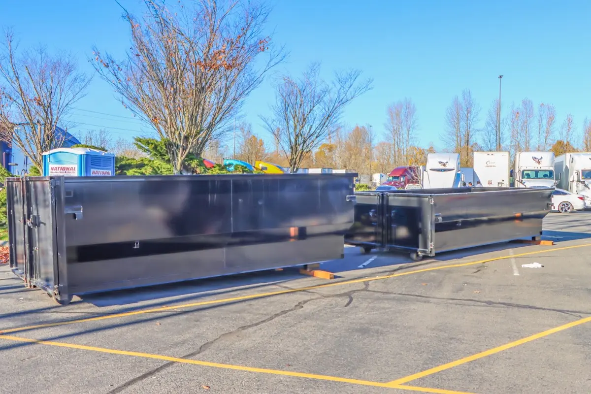 Professional dumpster rental service with roll-off container on residential driveway in Green Bay